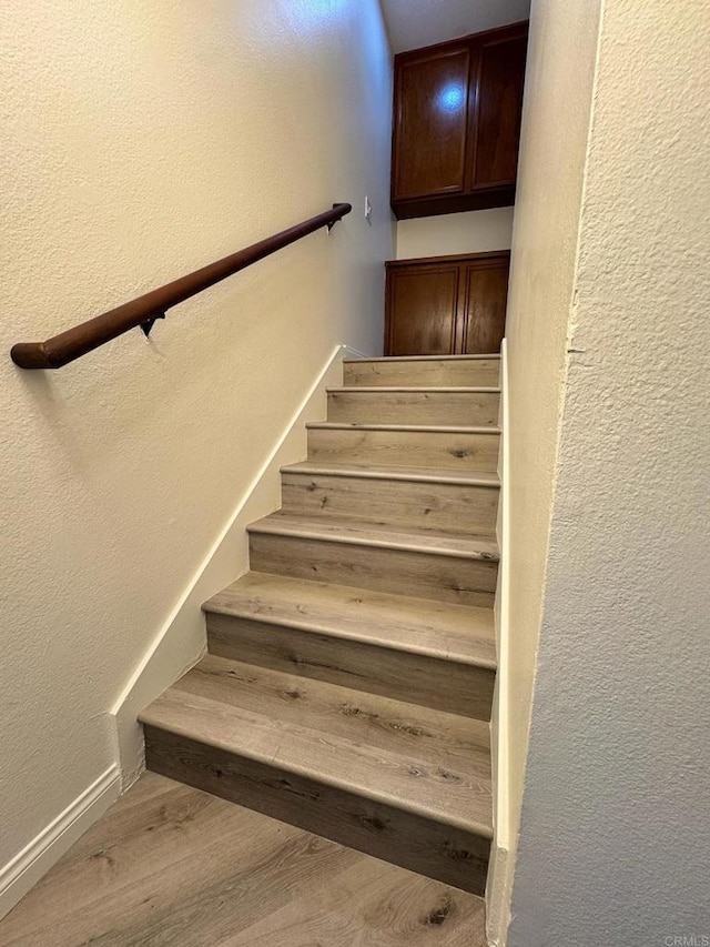 1103 Manzana Way, San Diego, CA 92139 - staircase with a textured wall and wood finished floors