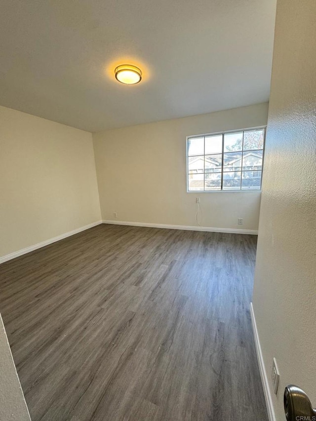 1103 Manzana Way, San Diego, CA 92139 - empty room featuring dark wood finished floors and baseboards