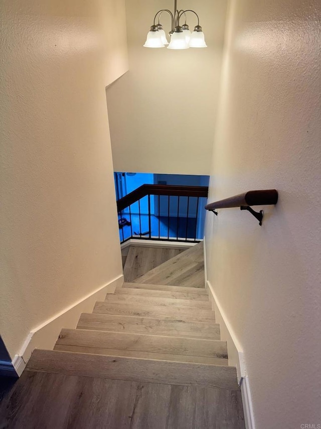 1103 Manzana Way, San Diego, CA 92139 - stairway with wood finished floors and a chandelier