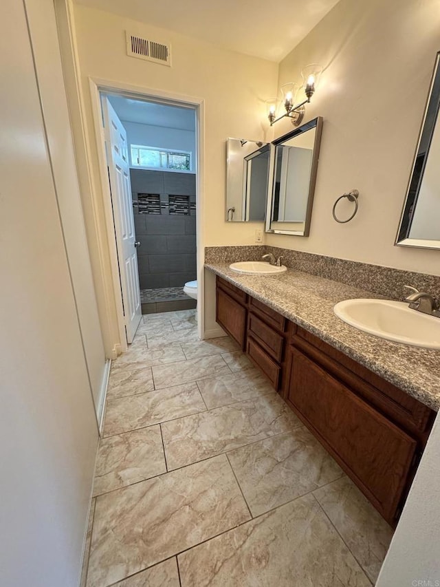 1103 Manzana Way, San Diego, CA 92139 - bathroom featuring double vanity, marble look tile flooring, and a tile shower