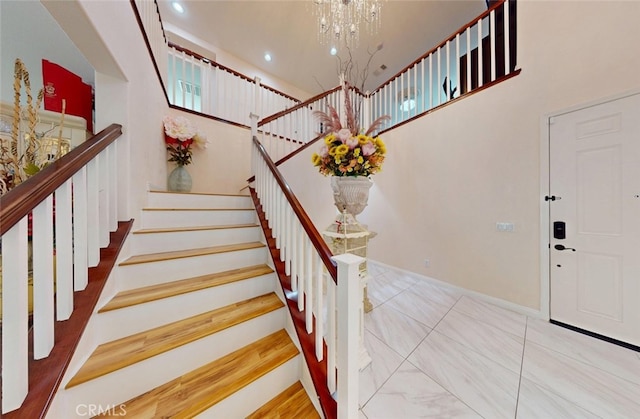 25664 Red Hawk Rd, Corona, CA 92883 - stairs with a chandelier, baseboards, recessed lighting, and a high ceiling