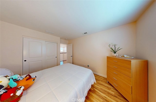 25664 Red Hawk Rd, Corona, CA 92883 - bedroom with light wood-style flooring, a closet, and baseboards