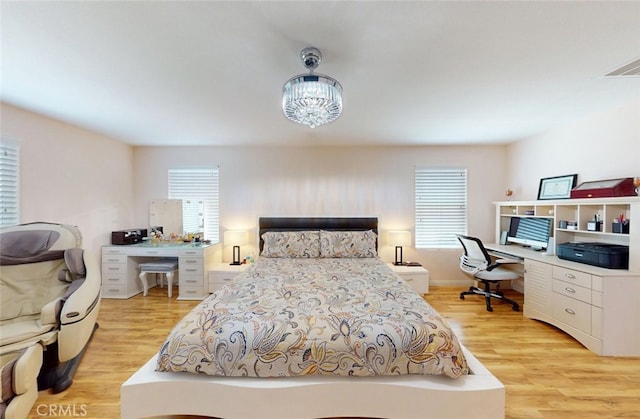 25664 Red Hawk Rd, Corona, CA 92883 - bedroom featuring an office area, light wood-style flooring, and a chandelier