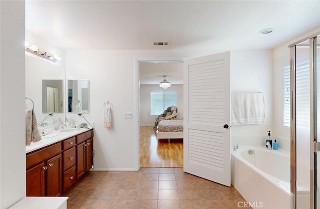 25664 Red Hawk Rd, Corona, CA 92883 - ensuite bathroom with double vanity, a bath, tile patterned floors, and baseboards