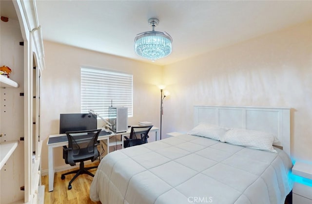 25664 Red Hawk Rd, Corona, CA 92883 - bedroom with light wood finished floors, a desk, and a chandelier
