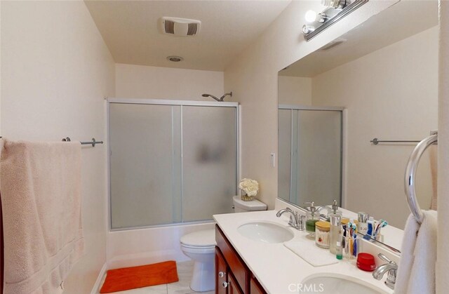 25664 Red Hawk Rd, Corona, CA 92883 - bathroom featuring double vanity, toilet, combined bath / shower with glass door, and tile patterned floors