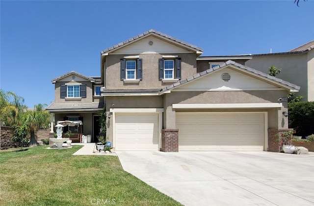 25664 Red Hawk Rd, Corona, CA 92883 - traditional-style home with concrete driveway, a tile roof, a front yard, stucco siding, and brick siding