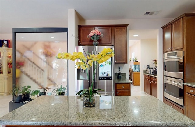 25664 Red Hawk Rd, Corona, CA 92883 - kitchen with stainless steel appliances, light stone counters, and a kitchen island