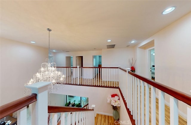 25664 Red Hawk Rd, Corona, CA 92883 - stairs featuring recessed lighting, wood finished floors, and a chandelier