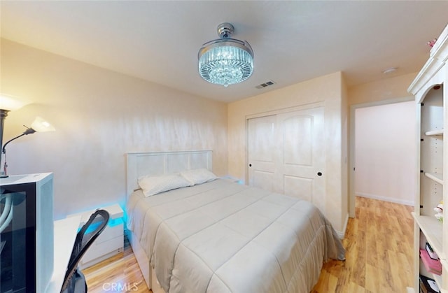 25664 Red Hawk Rd, Corona, CA 92883 - bedroom with light wood-type flooring and a closet