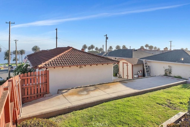 900 W 37th St, San Pedro, CA 90731 - rear view of property with stucco siding, a tile roof, a patio area, and an outdoor structure