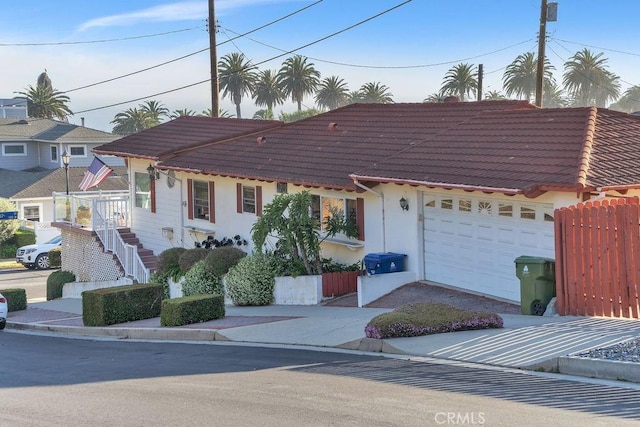 900 W 37th St, San Pedro, CA 90731 - view of front of house featuring a garage, a tile roof, concrete driveway, and stucco siding
