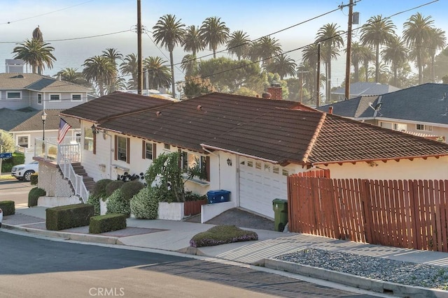 900 W 37th St, San Pedro, CA 90731 - view of front facade with a tiled roof, an attached garage, a chimney, and driveway