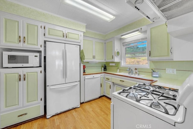 900 W 37th St, San Pedro, CA 90731 - kitchen with white appliances, a sink, tile counters, light wood finished floors, and decorative backsplash