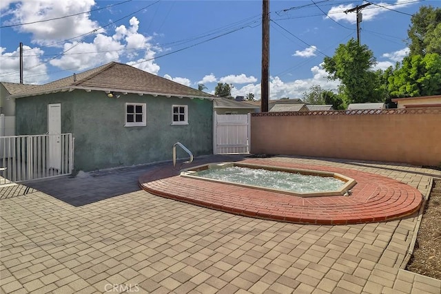 3411 W Chandler Blvd, Burbank, CA 91505 - view of patio / terrace featuring an outdoor hot tub and a gate