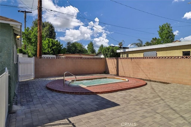 3411 W Chandler Blvd, Burbank, CA 91505 - fenced backyard with an in-ground hot tub, a gate, and a patio area