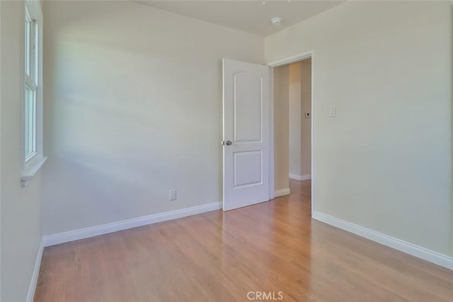3411 W Chandler Blvd, Burbank, CA 91505 - spare room featuring light wood-style flooring, baseboards, and a smoke detector