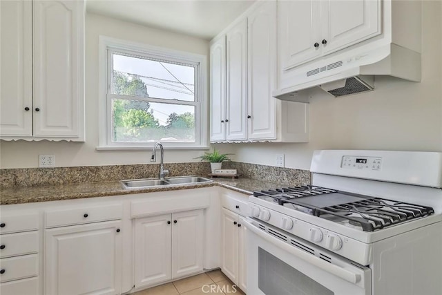 3411 W Chandler Blvd, Burbank, CA 91505 - kitchen with white range with gas stovetop, under cabinet range hood, a sink, white cabinetry, and dark stone countertops