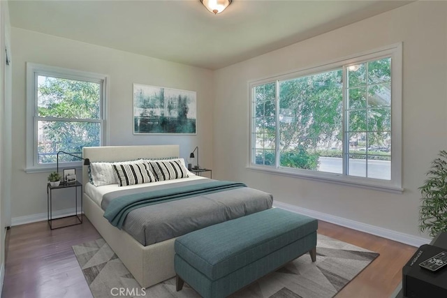3411 W Chandler Blvd, Burbank, CA 91505 - bedroom featuring multiple windows, baseboards, and wood finished floors