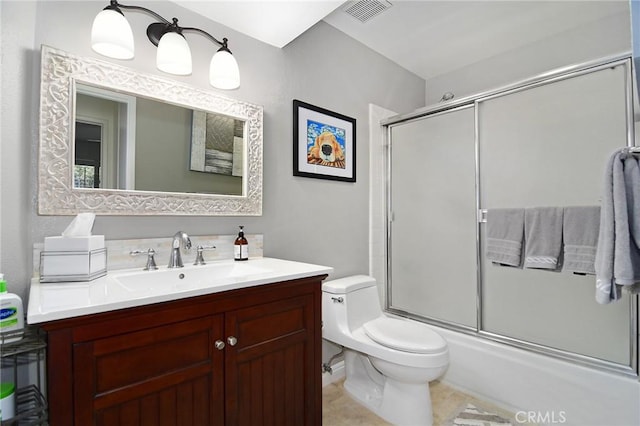 20950 Oxnard St Unit 11, Woodland Hills, CA 91367 - bathroom featuring toilet, vanity, combined bath / shower with glass door, and tile patterned flooring