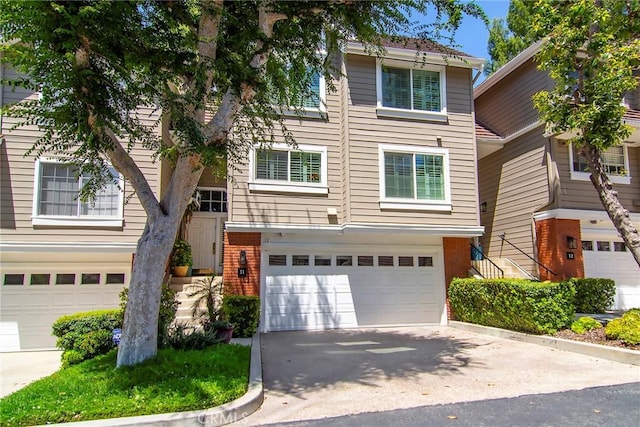 20950 Oxnard St Unit 11, Woodland Hills, CA 91367 - view of front of home with a garage, brick siding, and driveway