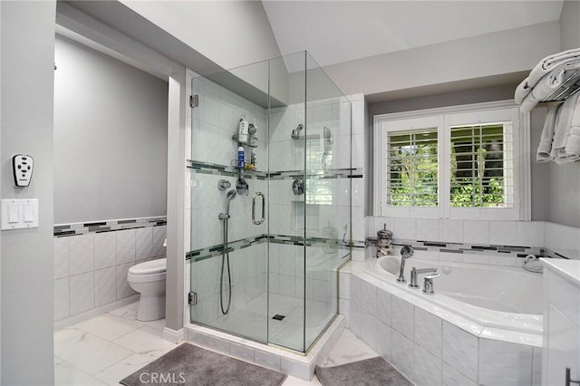 20950 Oxnard St Unit 11, Woodland Hills, CA 91367 - full bath featuring tile walls, marble look tile flooring, a bath, a stall shower, and toilet