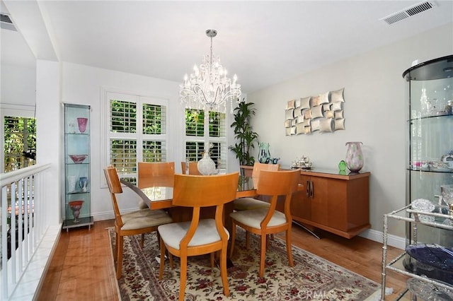20950 Oxnard St Unit 11, Woodland Hills, CA 91367 - dining space featuring wood finished floors, a chandelier, and baseboards