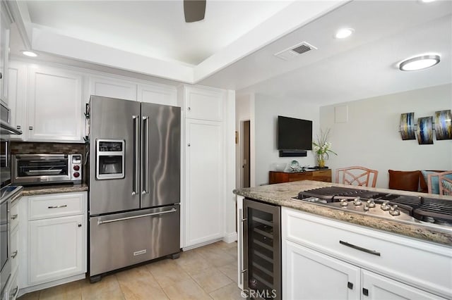 20950 Oxnard St Unit 11, Woodland Hills, CA 91367 - kitchen featuring appliances with stainless steel finishes, beverage cooler, white cabinets, light stone counters, and recessed lighting