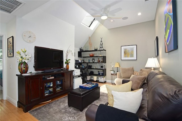 20950 Oxnard St Unit 11, Woodland Hills, CA 91367 - living room with a ceiling fan, wood finished floors, vaulted ceiling, baseboards, and a skylight