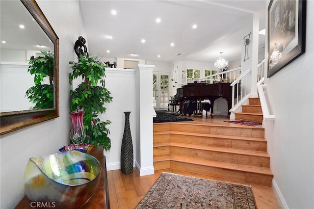 20950 Oxnard St Unit 11, Woodland Hills, CA 91367 - stairs with a chandelier, wood finished floors, recessed lighting, and baseboards
