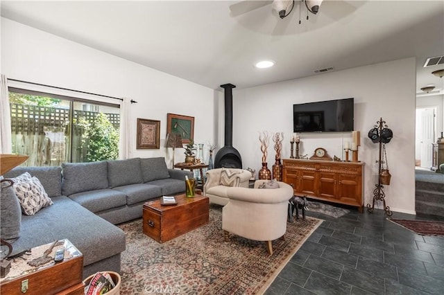 402 9th St, Paso Robles, CA 93446 - living room featuring ceiling fan, a wood stove, baseboards, and recessed lighting