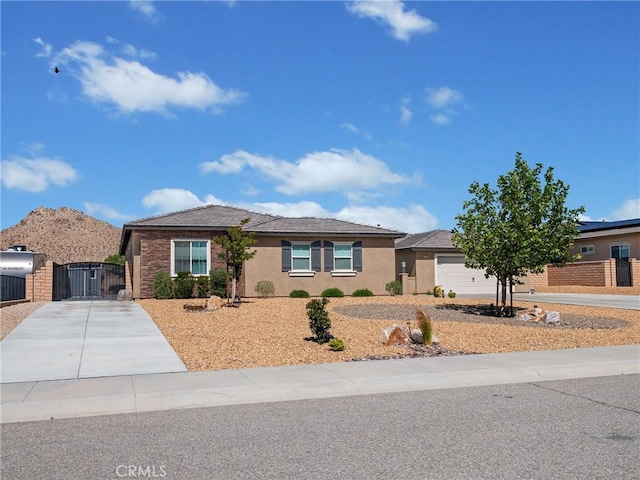 17028 Ta Ki Pi Rd, Apple Valley, CA 92307 - ranch-style home with driveway, a gate, stucco siding, and an attached garage
