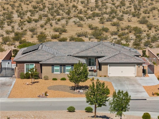 17028 Ta Ki Pi Rd, Apple Valley, CA 92307 - ranch-style house with a gate, stucco siding, a tile roof, driveway, and an attached garage