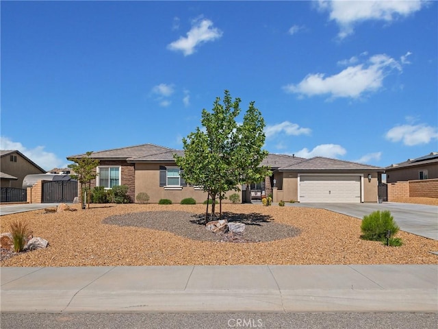 17028 Ta Ki Pi Rd, Apple Valley, CA 92307 - ranch-style house featuring driveway, a garage, stucco siding, and a gate