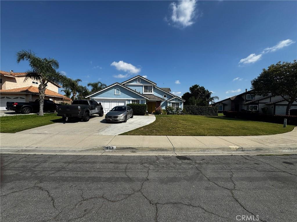 935 W Wabash St, Rialto, CA 92376 - view of front of house with driveway, a front yard, and an attached garage