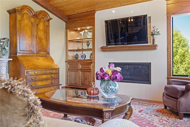 1760 Stuart St, Cambria, CA 93428 - living area with wood ceiling, a glass covered fireplace, wood finished floors, and built in shelves