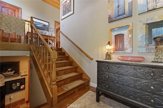 1760 Stuart St, Cambria, CA 93428 - stairs with wood finished floors, baseboards, and a high ceiling