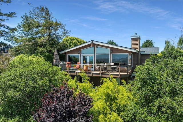 1760 Stuart St, Cambria, CA 93428 - rear view of house featuring a chimney and a wooden deck