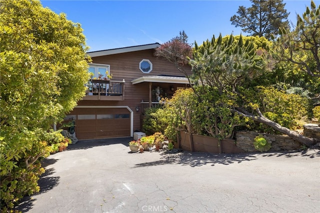 1760 Stuart St, Cambria, CA 93428 - view of front of house featuring a balcony, an attached garage, and asphalt driveway