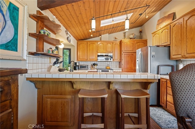 1760 Stuart St, Cambria, CA 93428 - kitchen featuring appliances with stainless steel finishes, open shelves, tile countertops, lofted ceiling, and wood ceiling