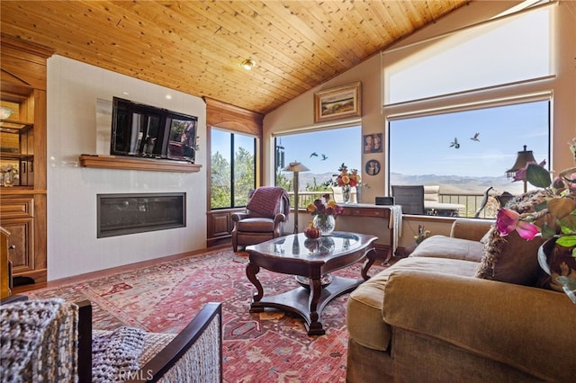 1760 Stuart St, Cambria, CA 93428 - living area with a glass covered fireplace, lofted ceiling, and wooden ceiling