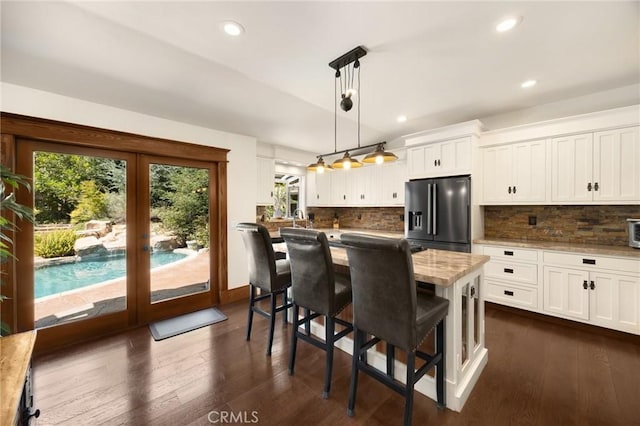 5121 E Lomita Ave, Orange, CA 92869 - kitchen with black fridge, french doors, white cabinetry, decorative backsplash, and recessed lighting