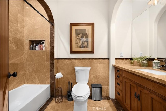 5121 E Lomita Ave, Orange, CA 92869 - bathroom with tile walls, vanity, toilet, a wainscoted wall, and tub / shower combination