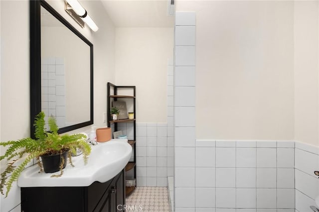 5121 E Lomita Ave, Orange, CA 92869 - bathroom featuring vanity, tile walls, and wainscoting