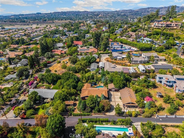 5121 E Lomita Ave, Orange, CA 92869 - aerial perspective of suburban area featuring a pool area and a mountain backdrop