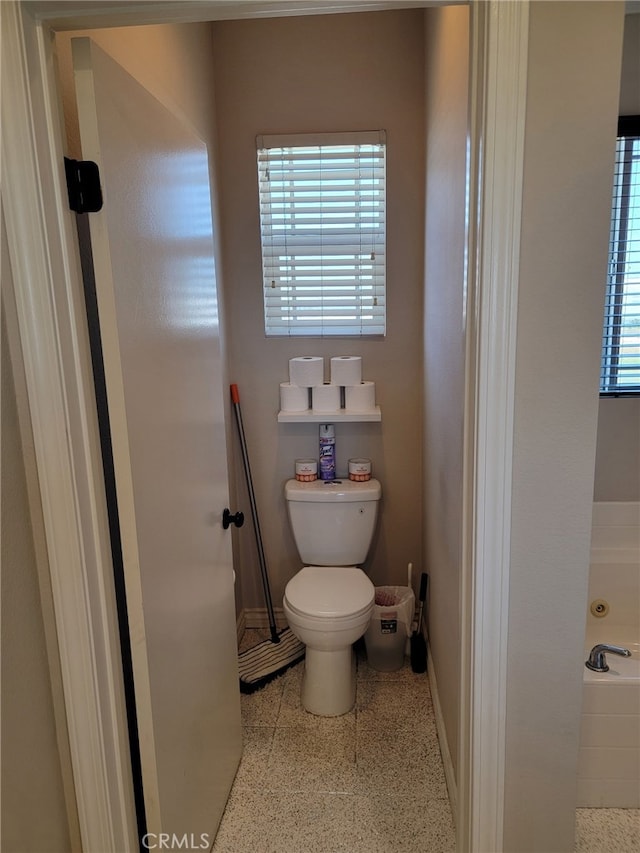 3052 Clapper St, Perris, CA 92571 - full bathroom featuring toilet, baseboards, and a bathtub