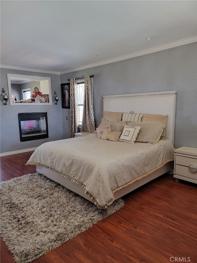3052 Clapper St, Perris, CA 92571 - bedroom with wood finished floors, crown molding, a glass covered fireplace, and baseboards