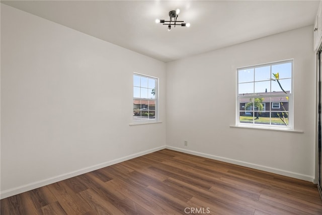 4033 N N Lang Ave, Covina, CA 91722 - unfurnished room featuring dark wood-style floors, baseboards, and a chandelier