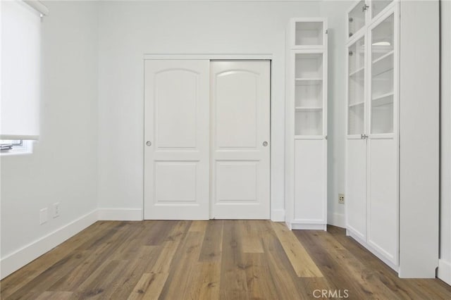4322 Alcove Ave, Studio City, CA 91604 - unfurnished bedroom with a closet, wood finished floors, and baseboards