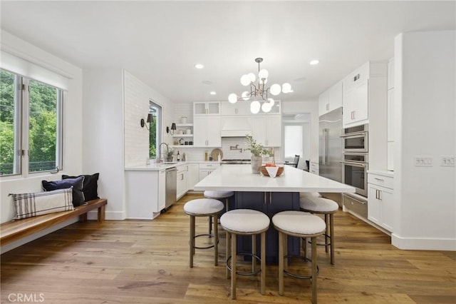 4322 Alcove Ave, Studio City, CA 91604 - kitchen with stainless steel appliances, a chandelier, plenty of natural light, white cabinets, and recessed lighting